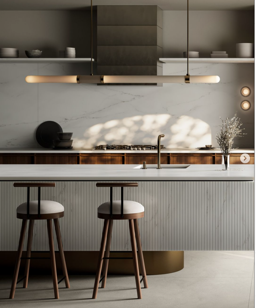 Cosentino Dekton Kitchen with soft grey and wood tones, with natural light shining through. Large textured island is the centre of the room with two bar stools.